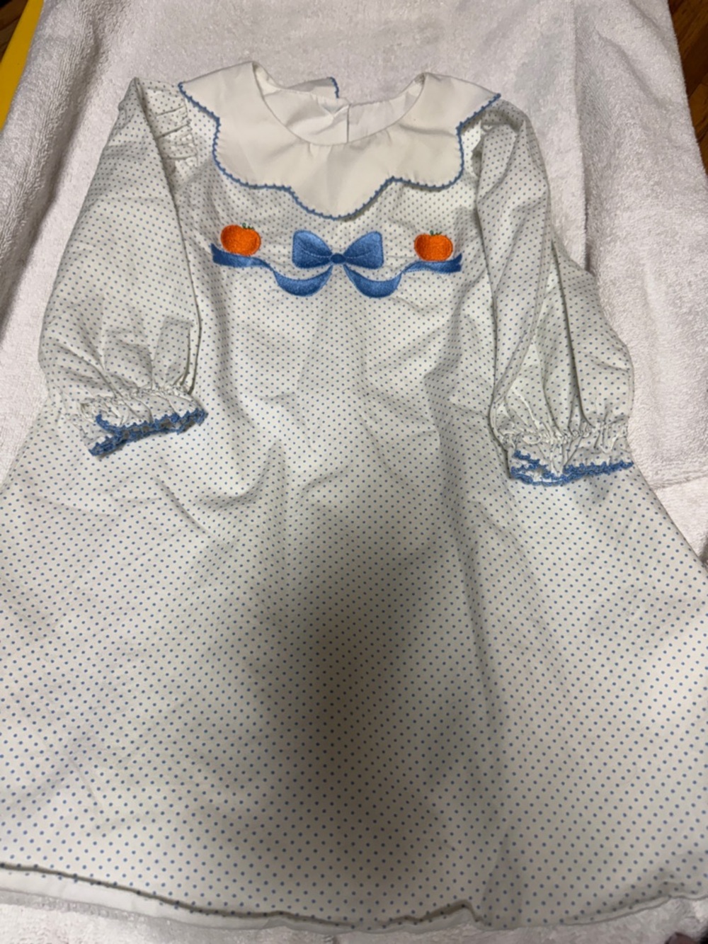 Classic White Polka Dot Girls Dress with Blue Trim and Orange Accents